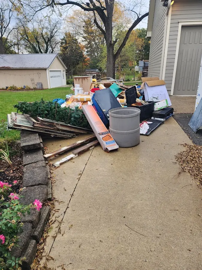 Dumpster being loaded with debris for Estate Cleanout Dumpster Rental in Evanston